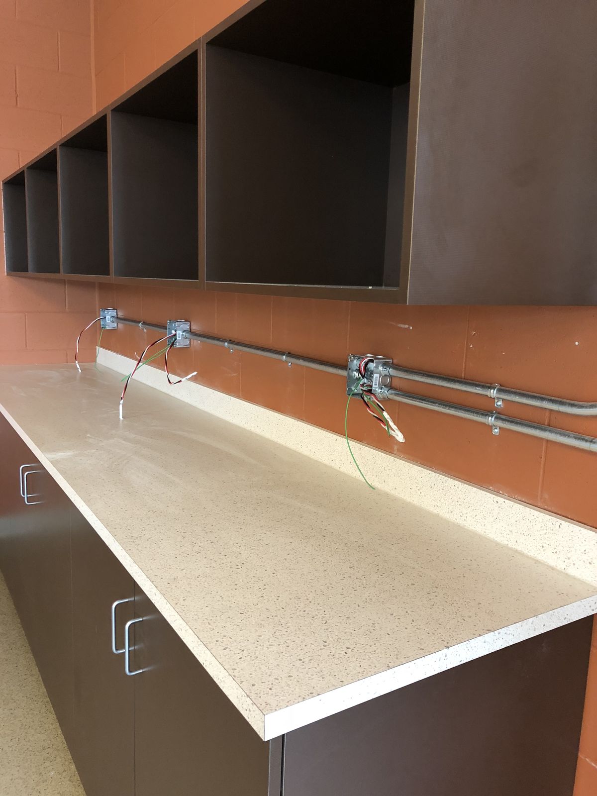 Conduit and outlet boxes installed above a new counter