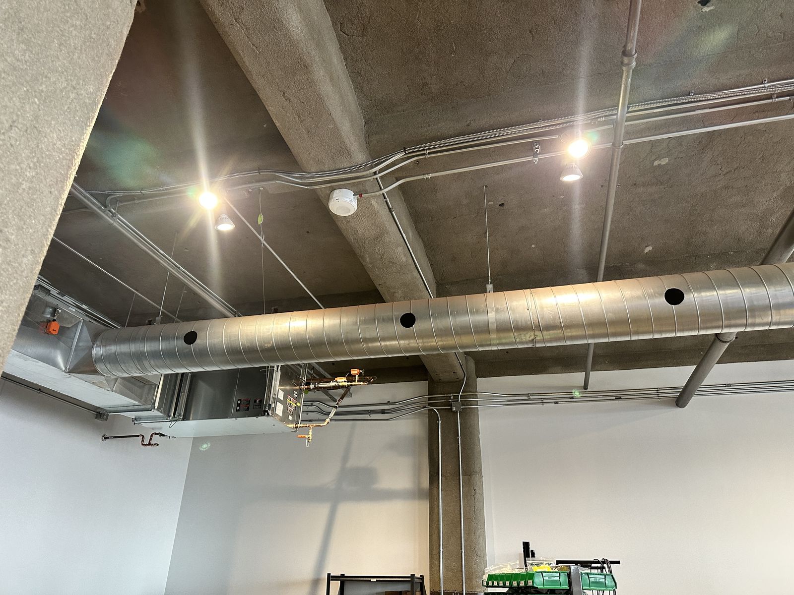 New flush LED ceiling fixtures in a concrete-walled room